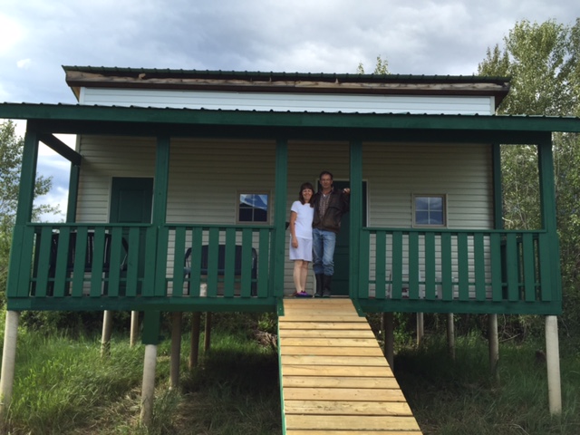 Gary & Karen standing at the entrance of the newly finsished cabin